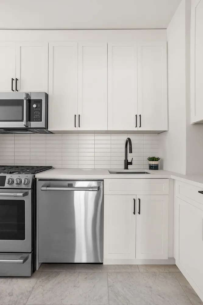 a kitchen with stainless steel appliances granite countertop a sink and a stove