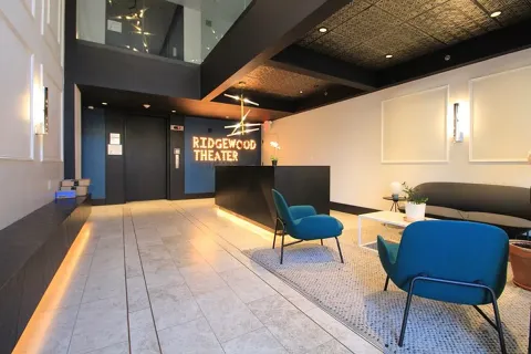 a lobby with furniture and a rug