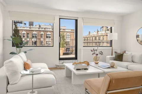 a living room with furniture flowerpot and a window
