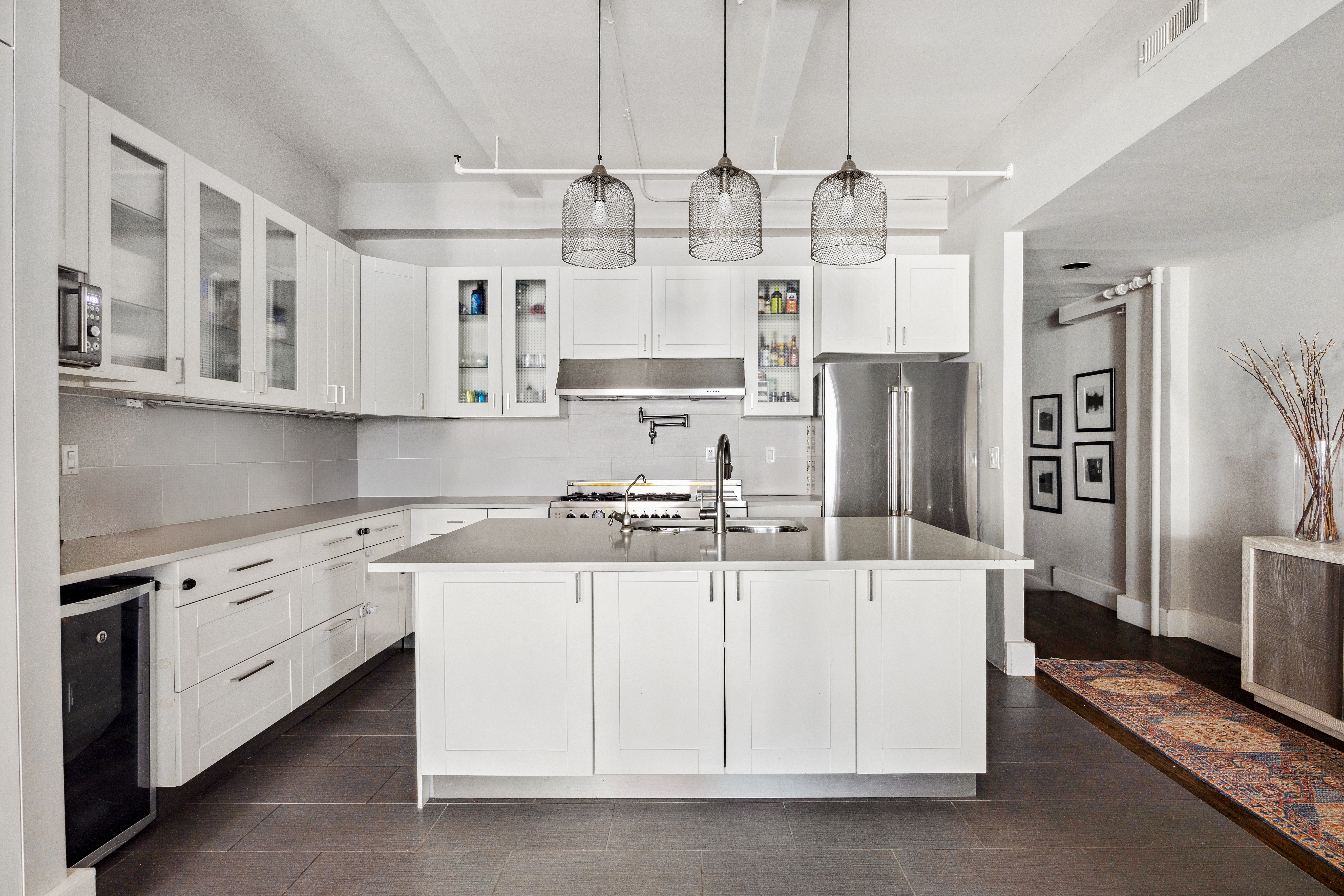 129 West 22nd Street, Unit 5A Manhattan, NY 10011 - Photo 5 of 13 a kitchen with stainless steel appliances a stove a sink and a refrigerator