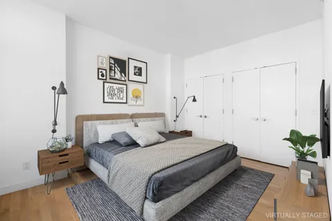 a bedroom with a bed and a potted plant