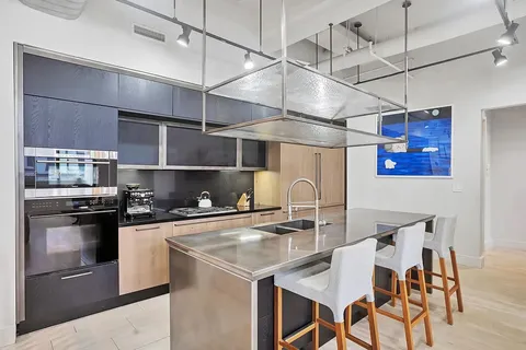 a kitchen with cabinets and stainless steel appliances