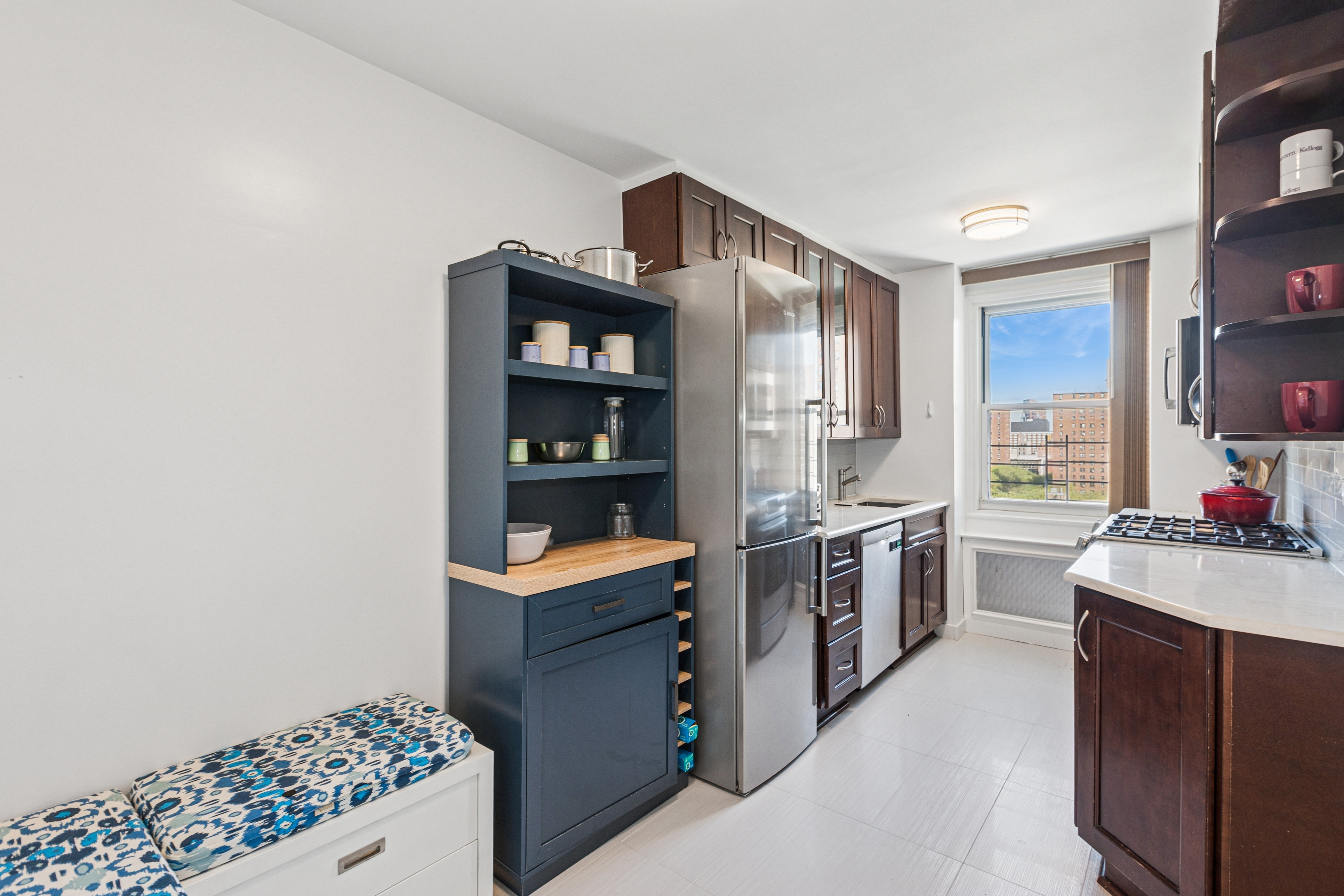 1270 5th Avenue, Unit 12C Manhattan, NY 10029 - Photo 5 of 18 a kitchen with stainless steel appliances a sink and a stove