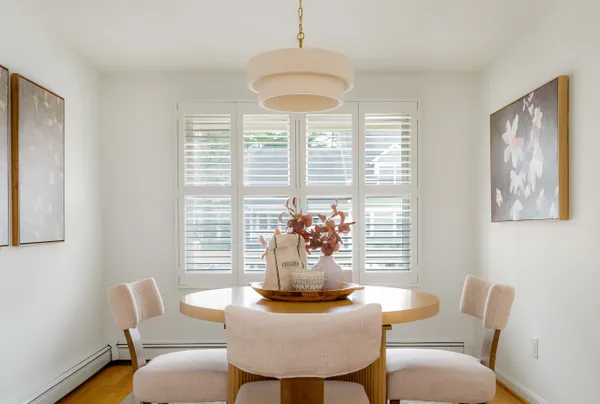 a dining room with furniture and window
