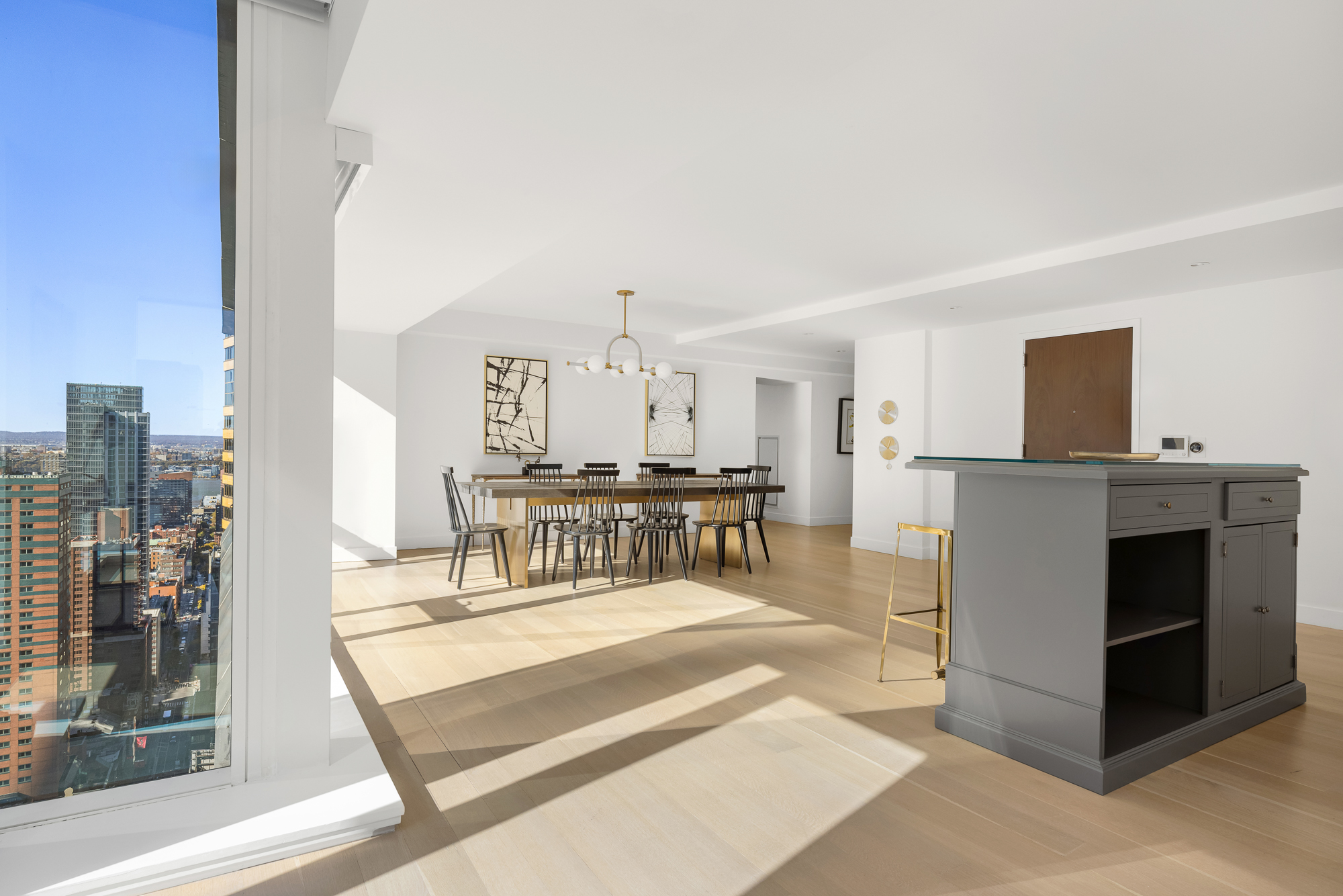 135 West 52nd Street, Unit 40A Manhattan, NY 10019 - Photo 8 of 24 a living room with furniture and a table