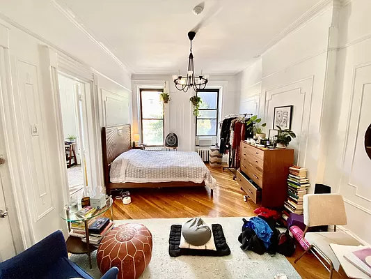 351 7th Avenue, Unit 2 Brooklyn, NY 11215 - Photo 1 of 10 a bedroom with furniture and a chandelier