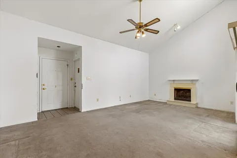 a living room with furniture a fireplace and a chandelier