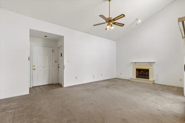 a living room with furniture a fireplace and a chandelier