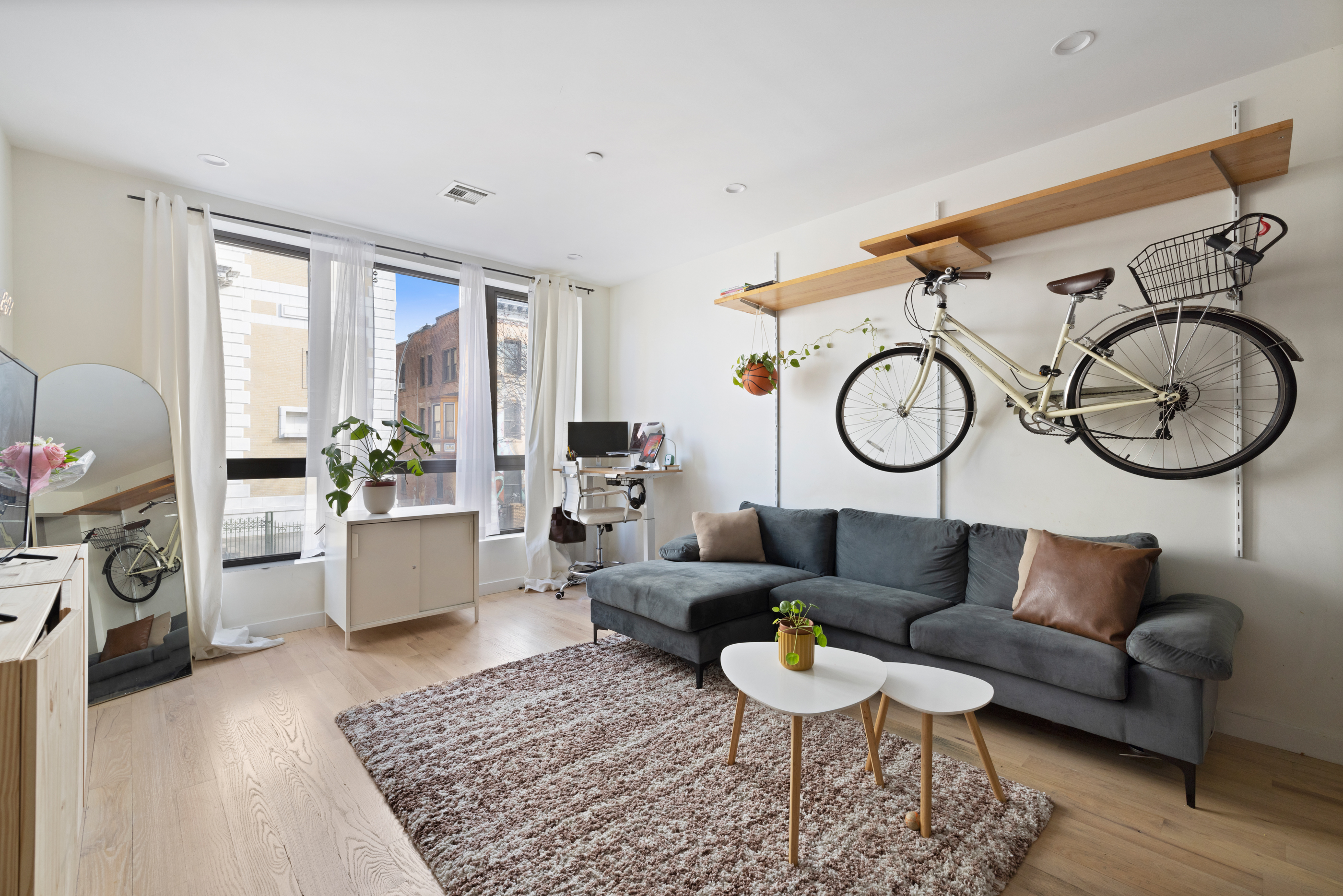 a living room with furniture a rug and a window