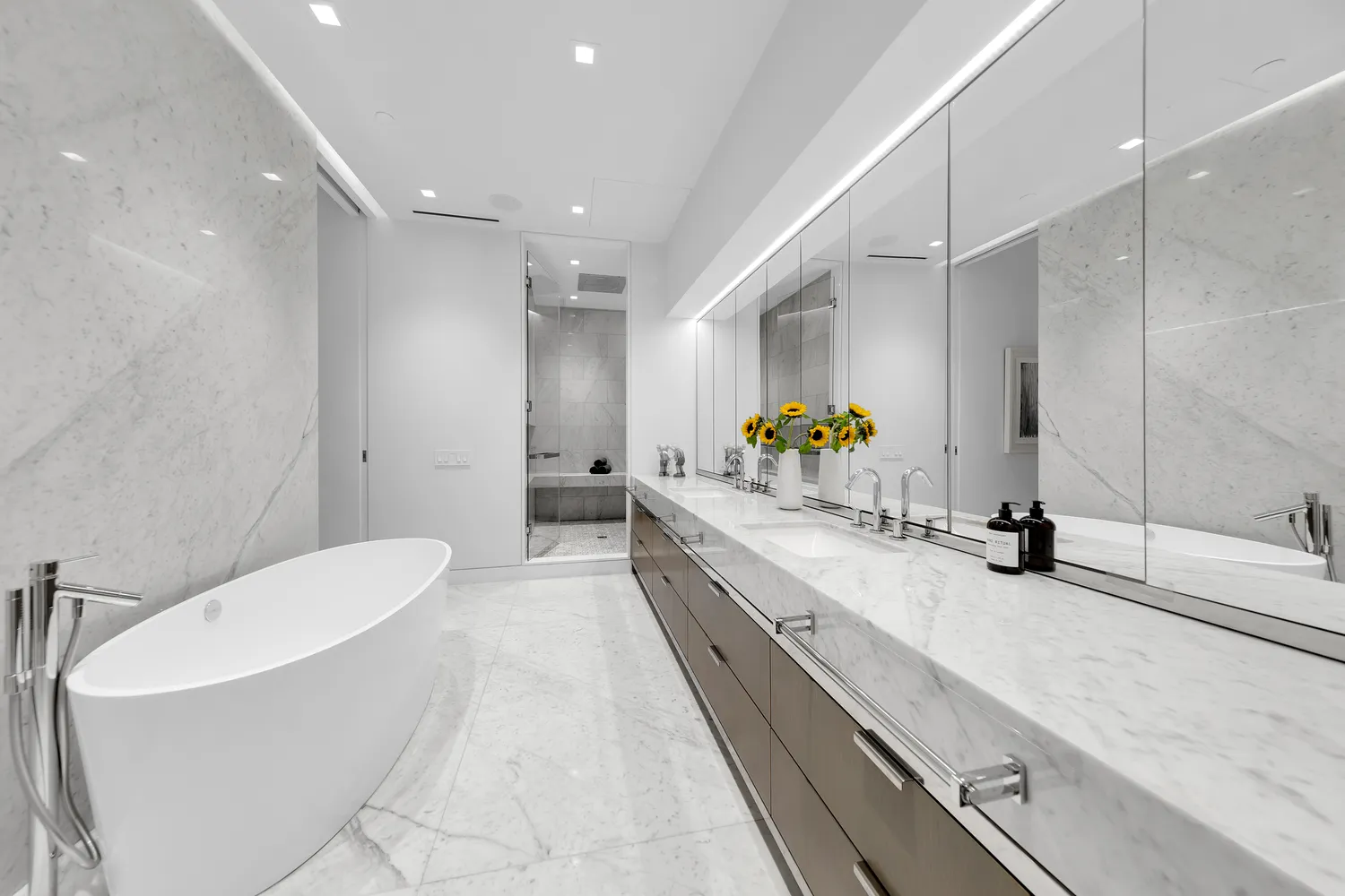 a bathroom with a double vanity sink toilet and a tub