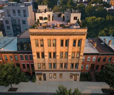 a front view of a building with windows and yard