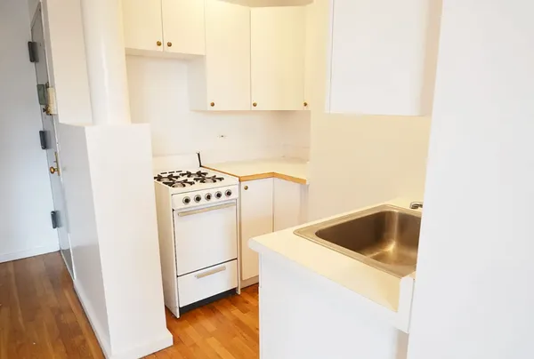 a kitchen with sink and cabinets