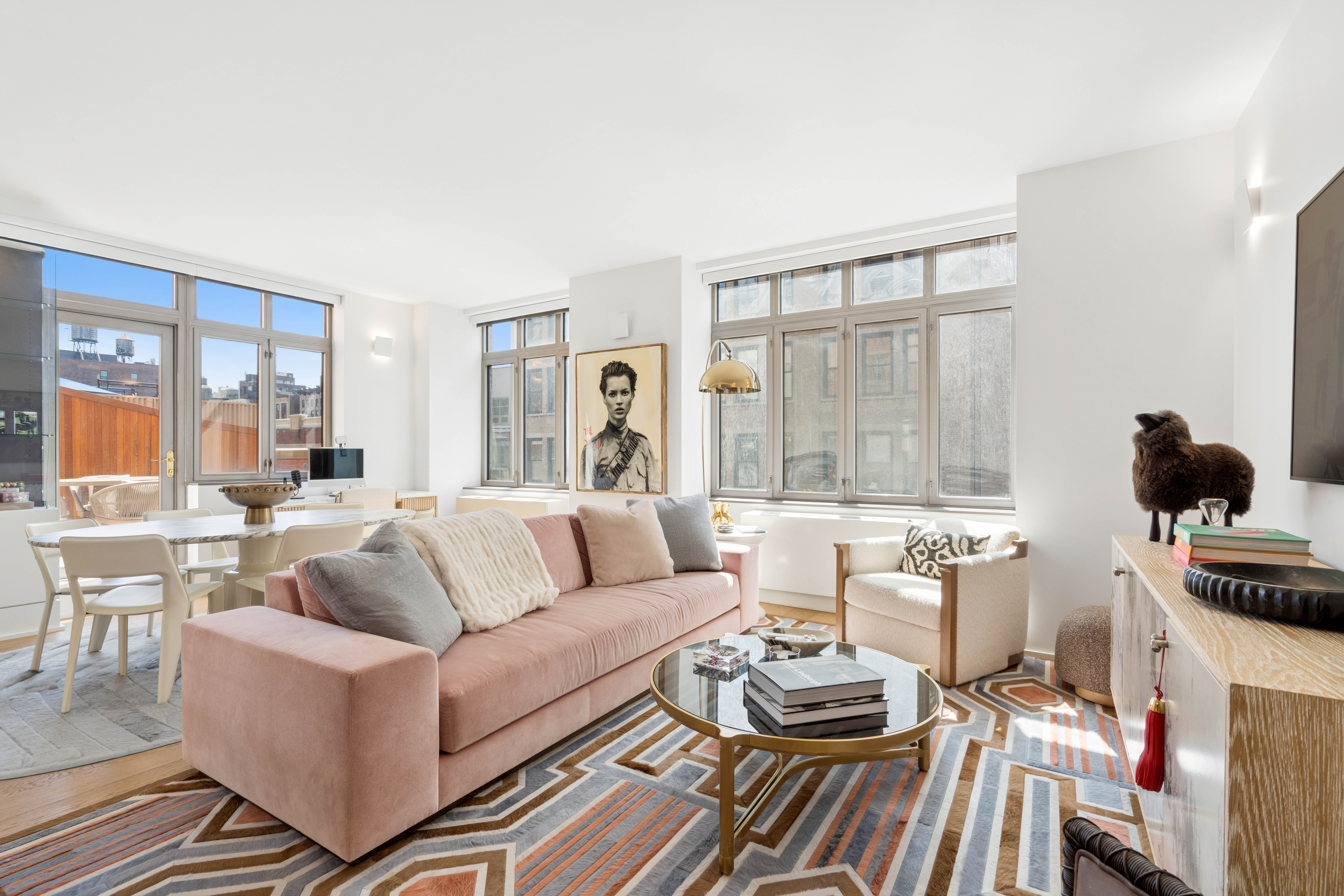 125 West 22nd Street, Unit 10A Manhattan, NY 10011 - Photo 2 of 11 a living room with furniture and a large window