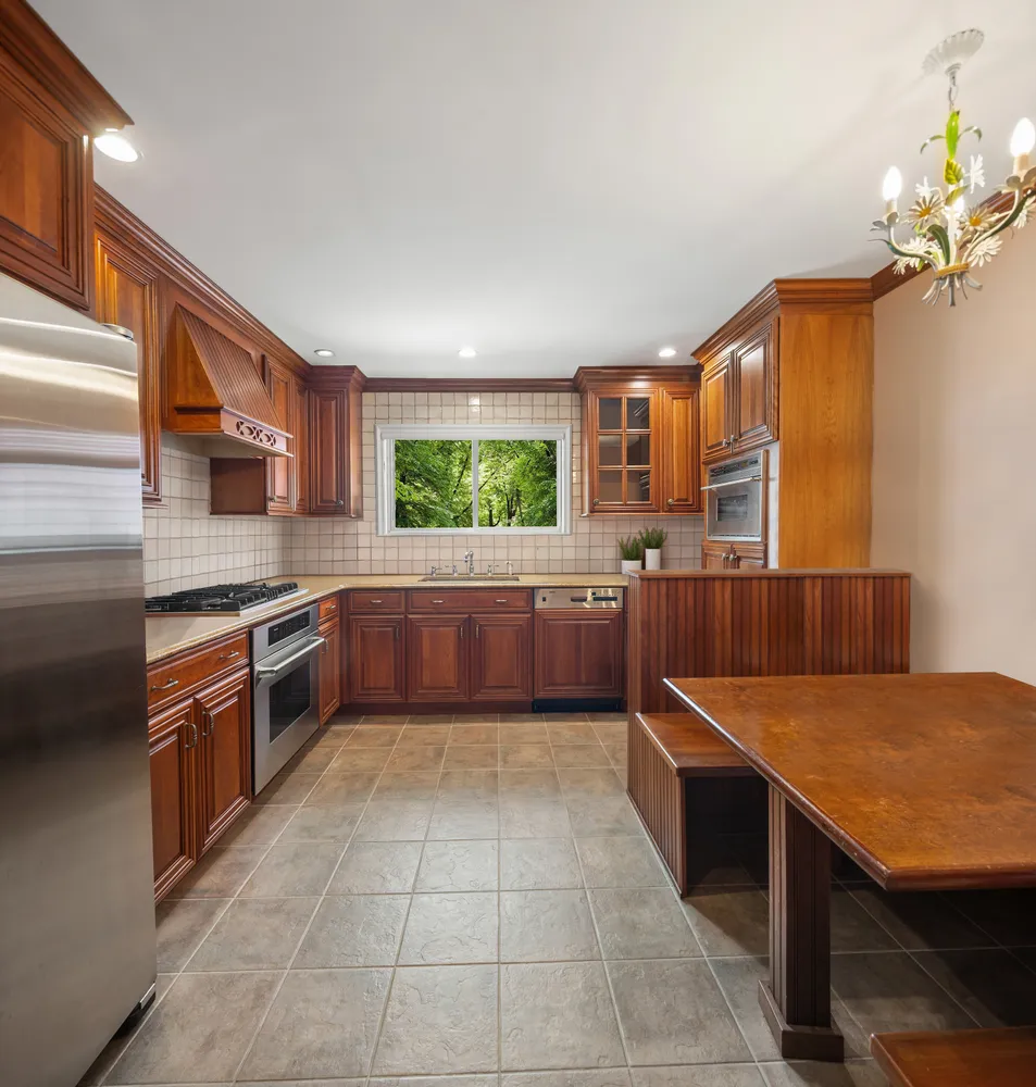 a kitchen with stainless steel appliances granite countertop a sink counter space cabinets and a large window