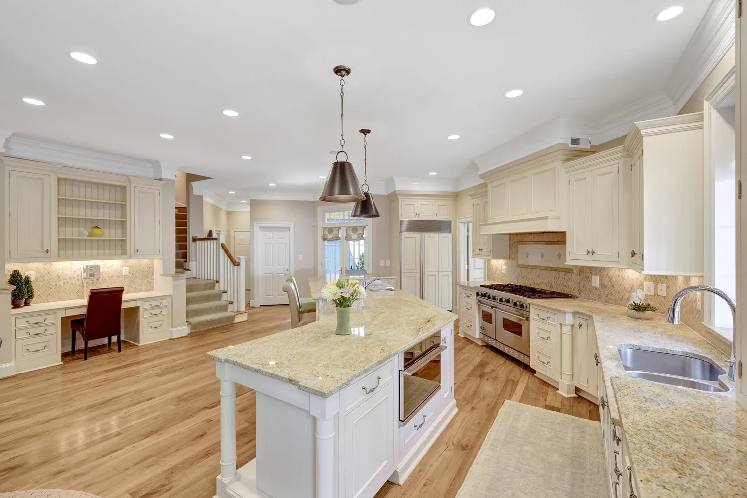 a view of a chandelier fan and wooden floor in a room