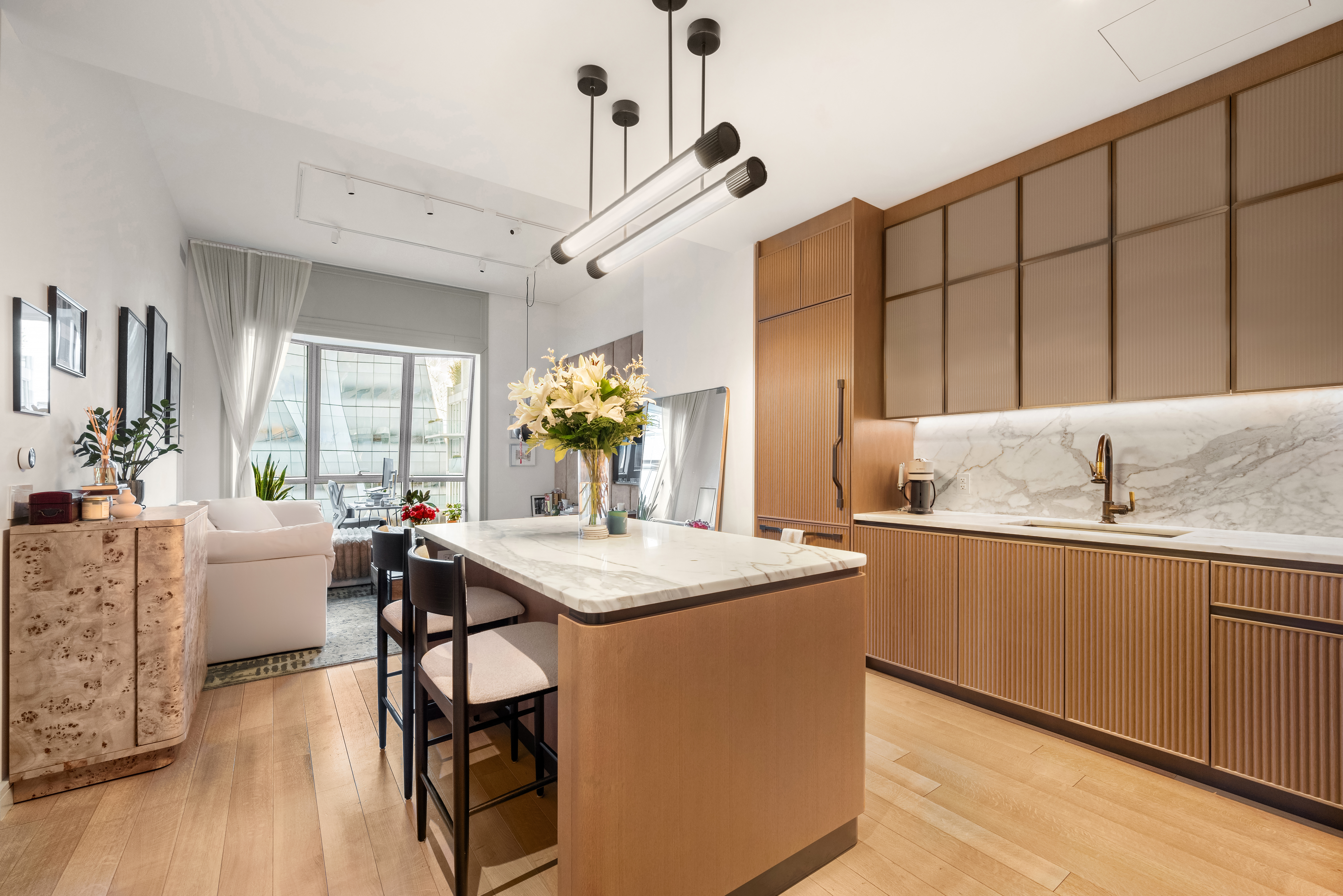 515 West 18th Street, Unit 901 Manhattan, NY 10011 - Photo 1 of 14 a kitchen with granite countertop a sink cabinets and wooden floor