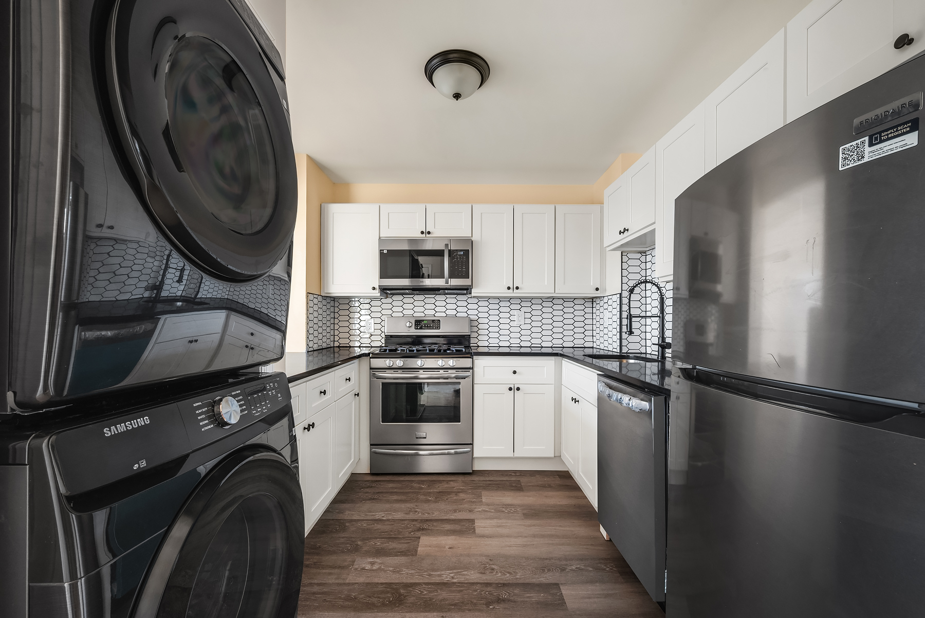 415 East 160th Street, Unit 3 Bronx, NY 10451 - Photo 8 of 10 a kitchen with granite countertop a refrigerator a stove and a sink