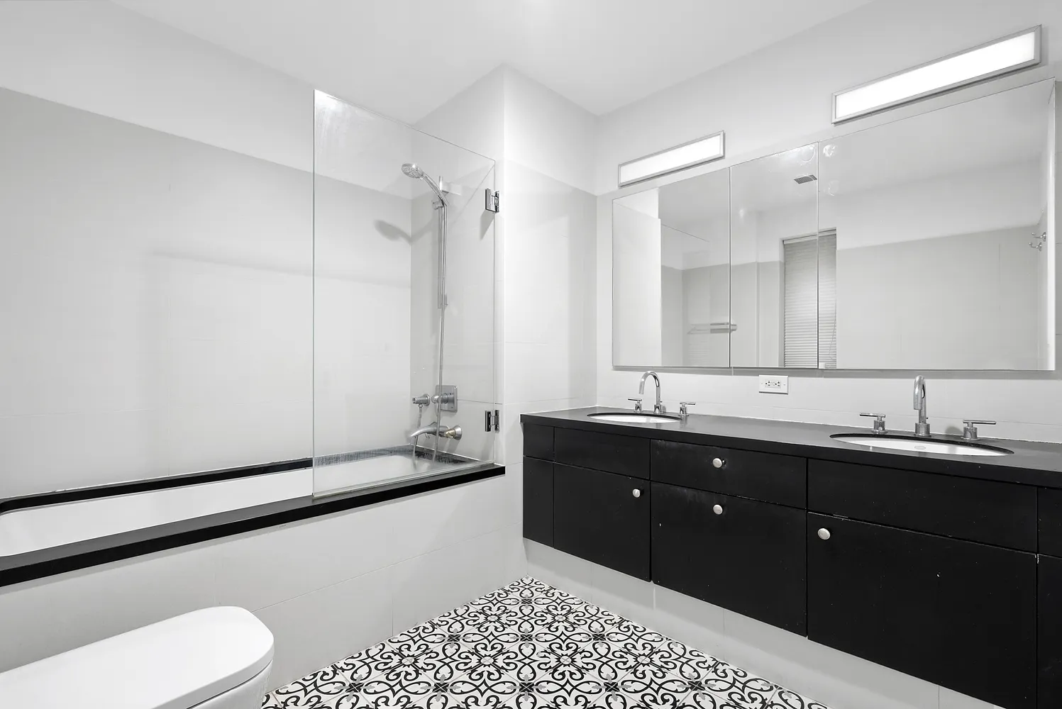 a spacious bathroom with a double vanity sink and mirror