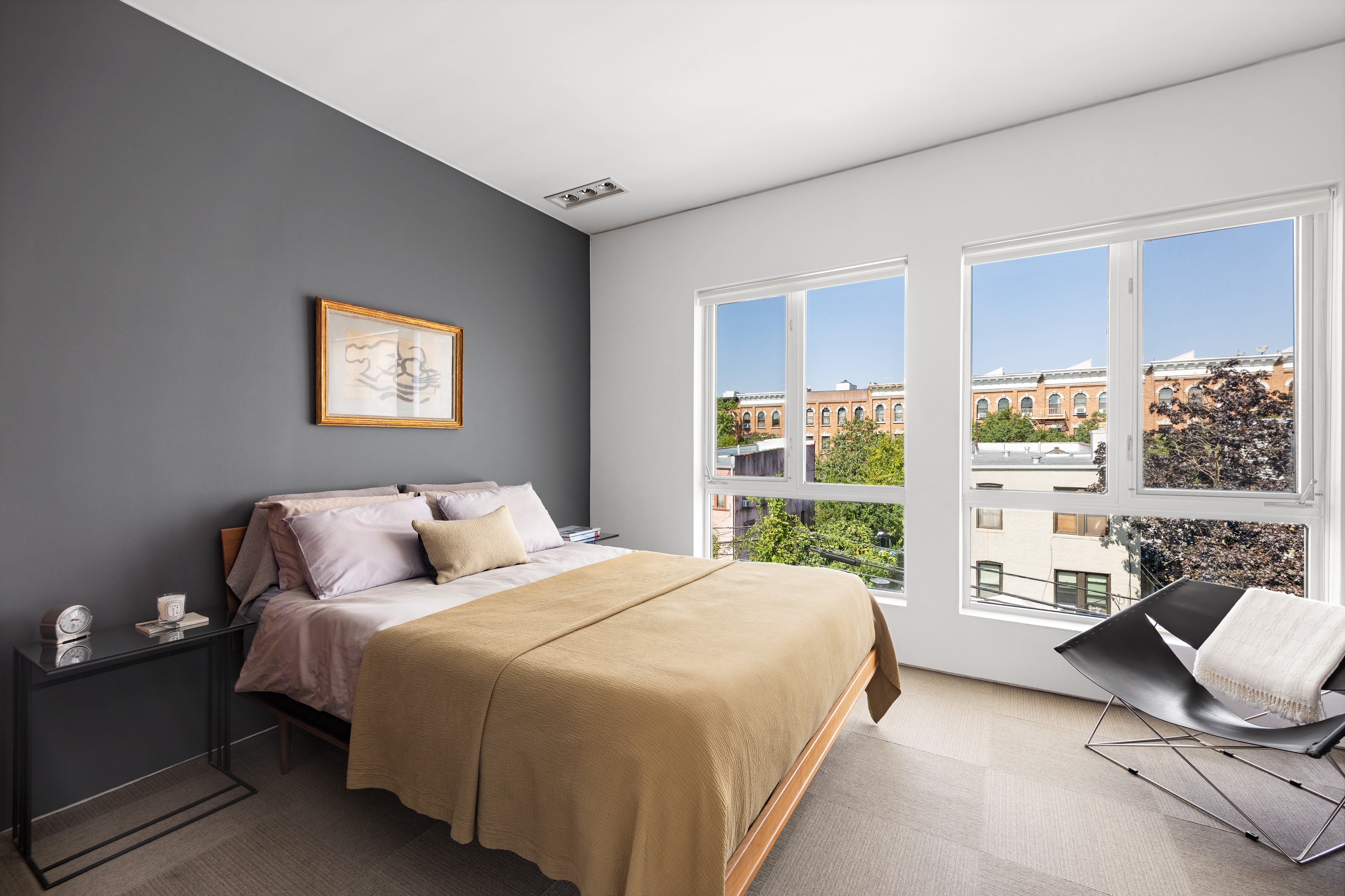 481 18th Street, Unit PH Brooklyn, NY 11215 - Photo 6 of 11 a bedroom with a bed couch and large window