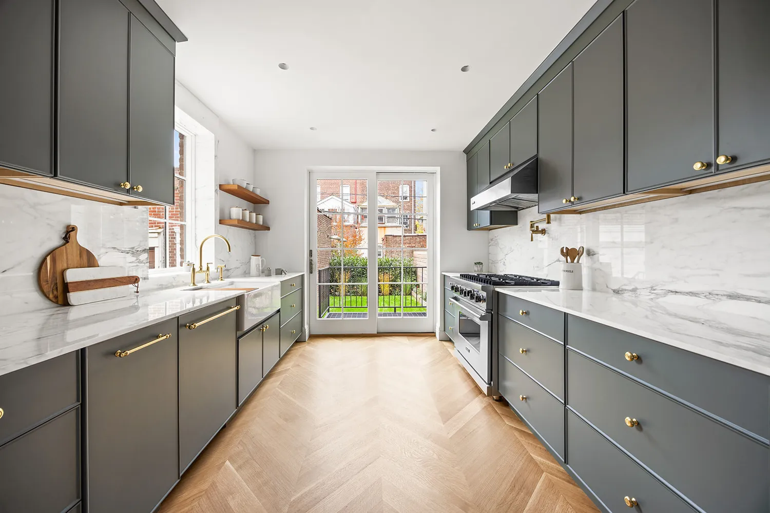 a kitchen with stainless steel appliances a sink stove and cabinets