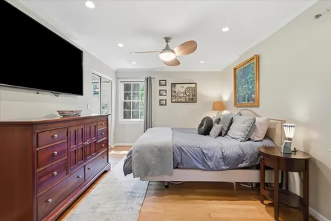 a bedroom with a bed and wooden floor