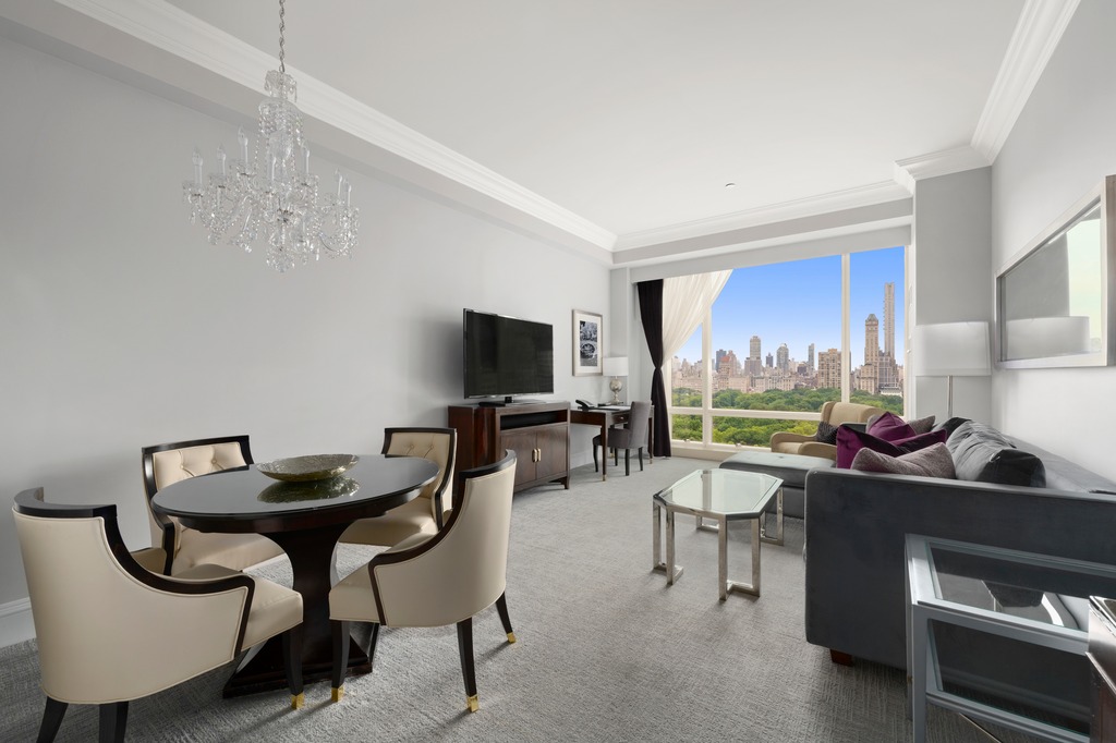 1 Central Park West, Unit 1506 Manhattan, NY 10023 - Photo 2 of 16 a living room with furniture and a flat screen tv