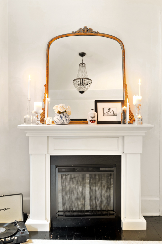 78 Bedford Street, Unit 4C Manhattan, NY 10014 - Photo 4 of 10 a living room with a fireplace and a mirror