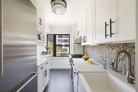 a kitchen with a sink and a refrigerator