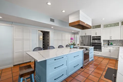 a kitchen with stainless steel appliances granite countertop a sink dishwasher a stove and a microwave oven