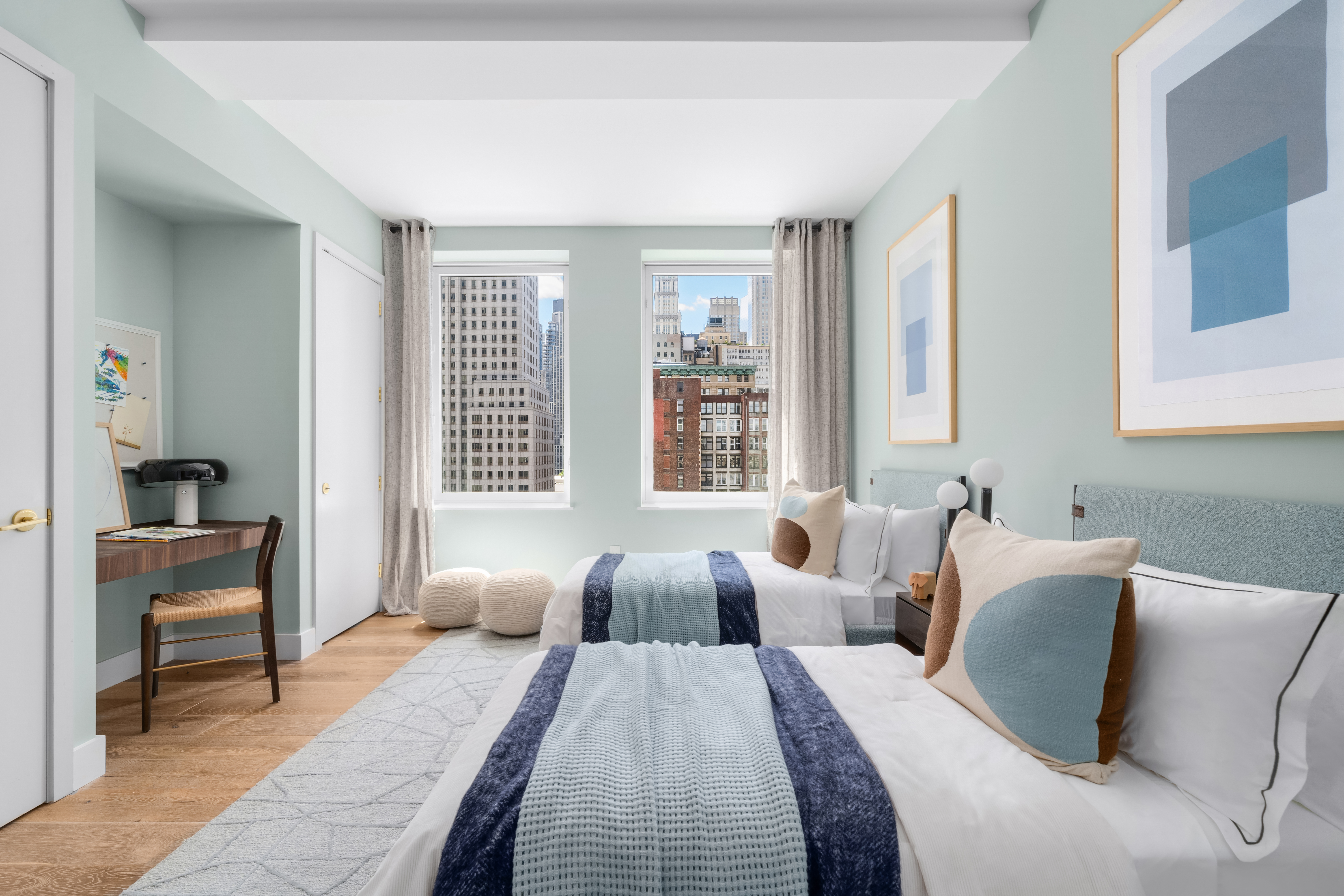 93 Worth Street, Unit PH5 Manhattan, NY 10013 - Photo 13 of 19 a bedroom with two beds and a large mirror next to a window