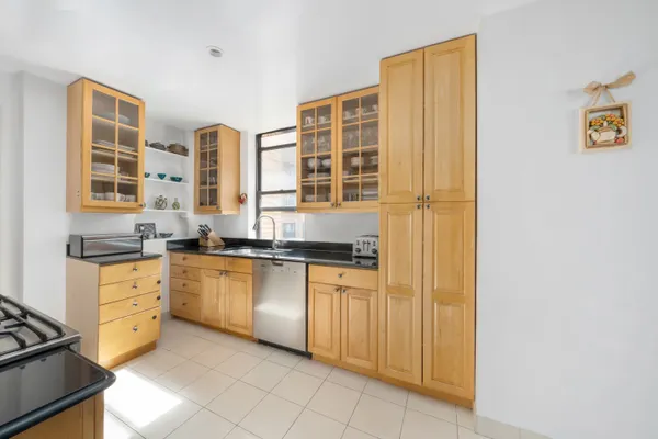 a kitchen with stainless steel appliances granite countertop a stove and a sink