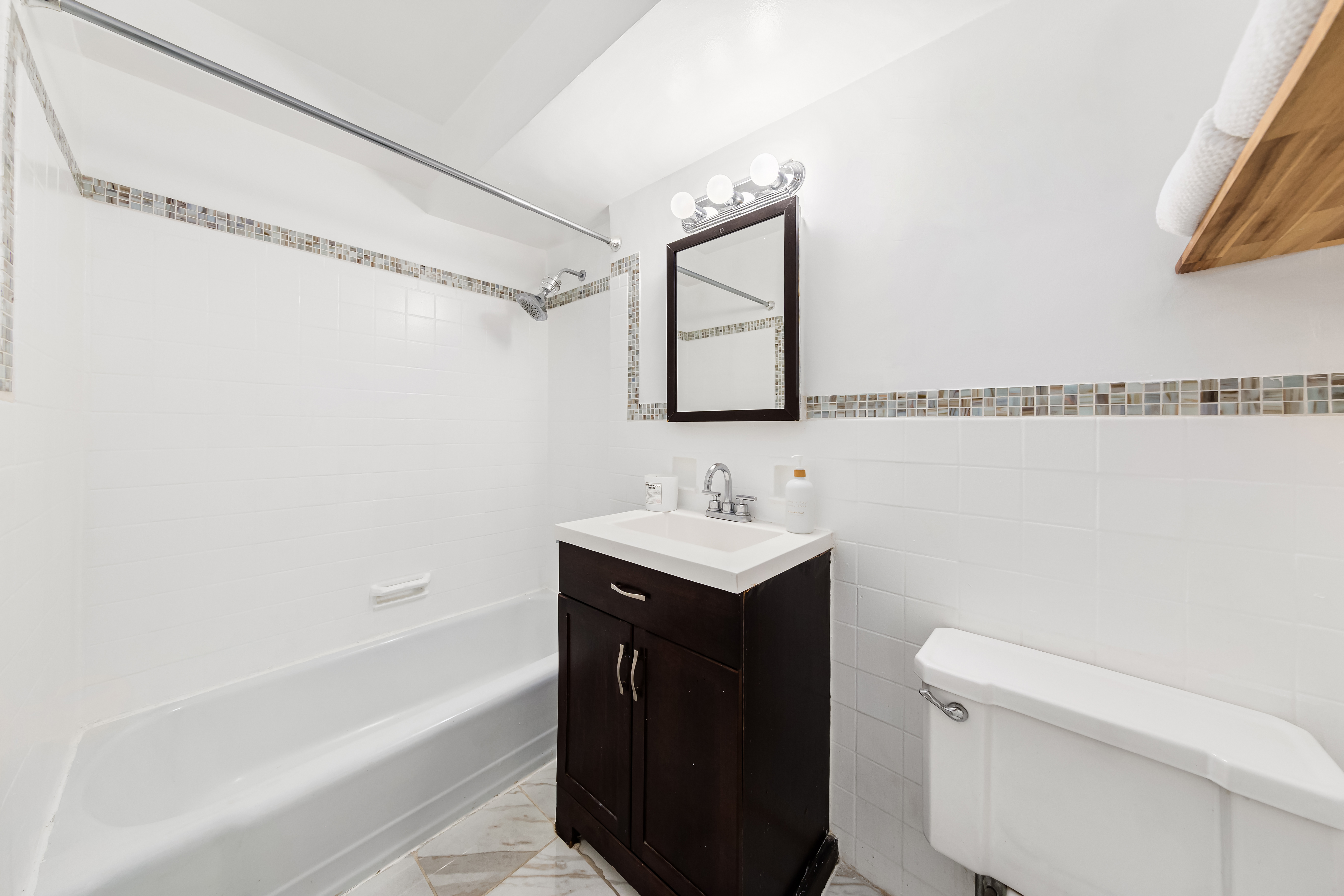 310 Lexington Avenue, Unit 3E Manhattan, NY 10016 - Photo 6 of 10 a bathroom with a sink a toilet and shower