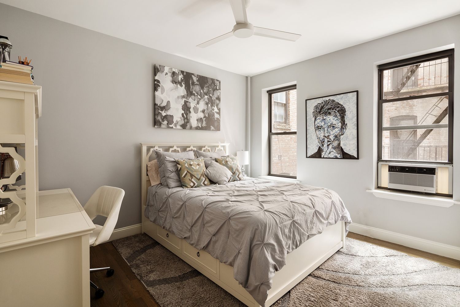 a bedroom with a bed and a painting on the wall