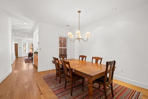 a view of a dining room with furniture wooden floor and chandelier