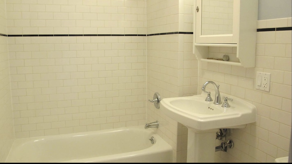 68 Downing Street, Unit 3 Brooklyn, NY 11238 - Photo 4 of 7 a white bath tub sitting next to a white sink and a shower