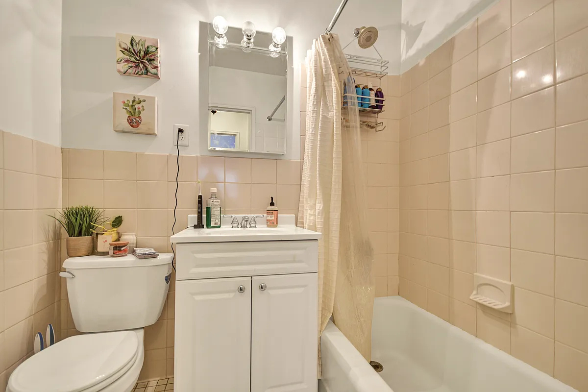 245 East 35th Street, Unit 9D Manhattan, NY 10016 - Photo 4 of 8 a bathroom with a sink a toilet and shower