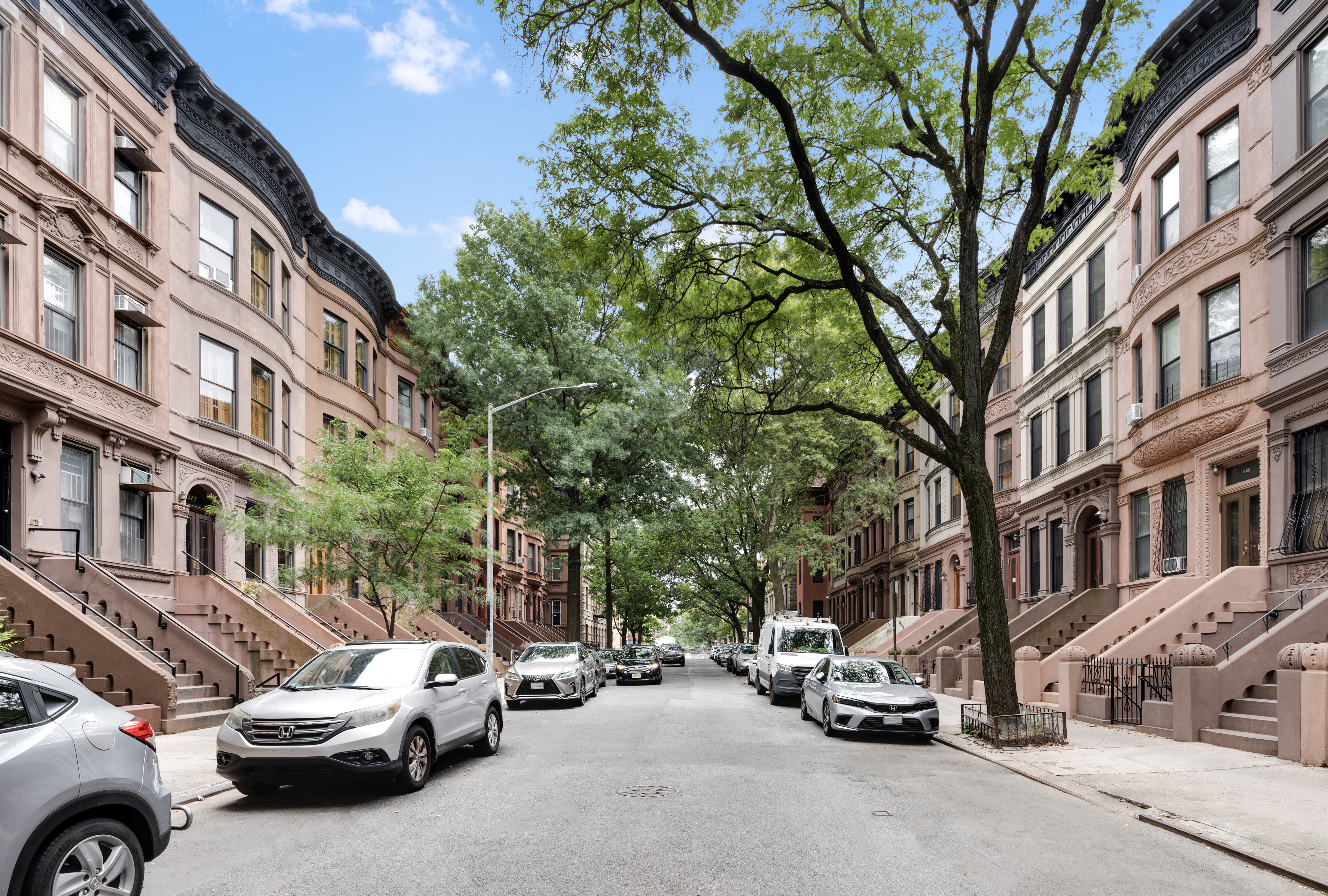 235 West 137th Street, Unit 4F Manhattan, NY 10030 - Photo 6 of 7 a view of a cars park in front of a building