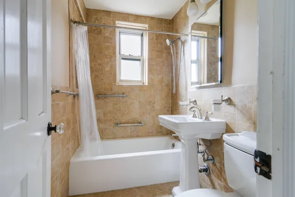 a bathroom with a sink mirror toilet and bathtub
