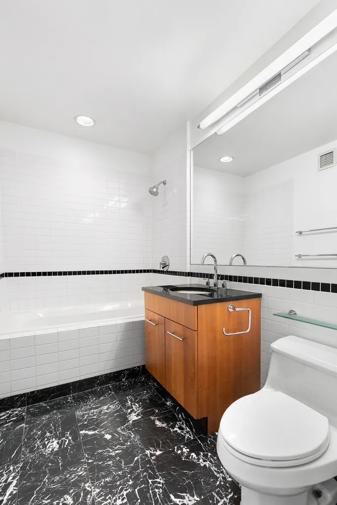 a bathroom with a toilet a sink and bathtub