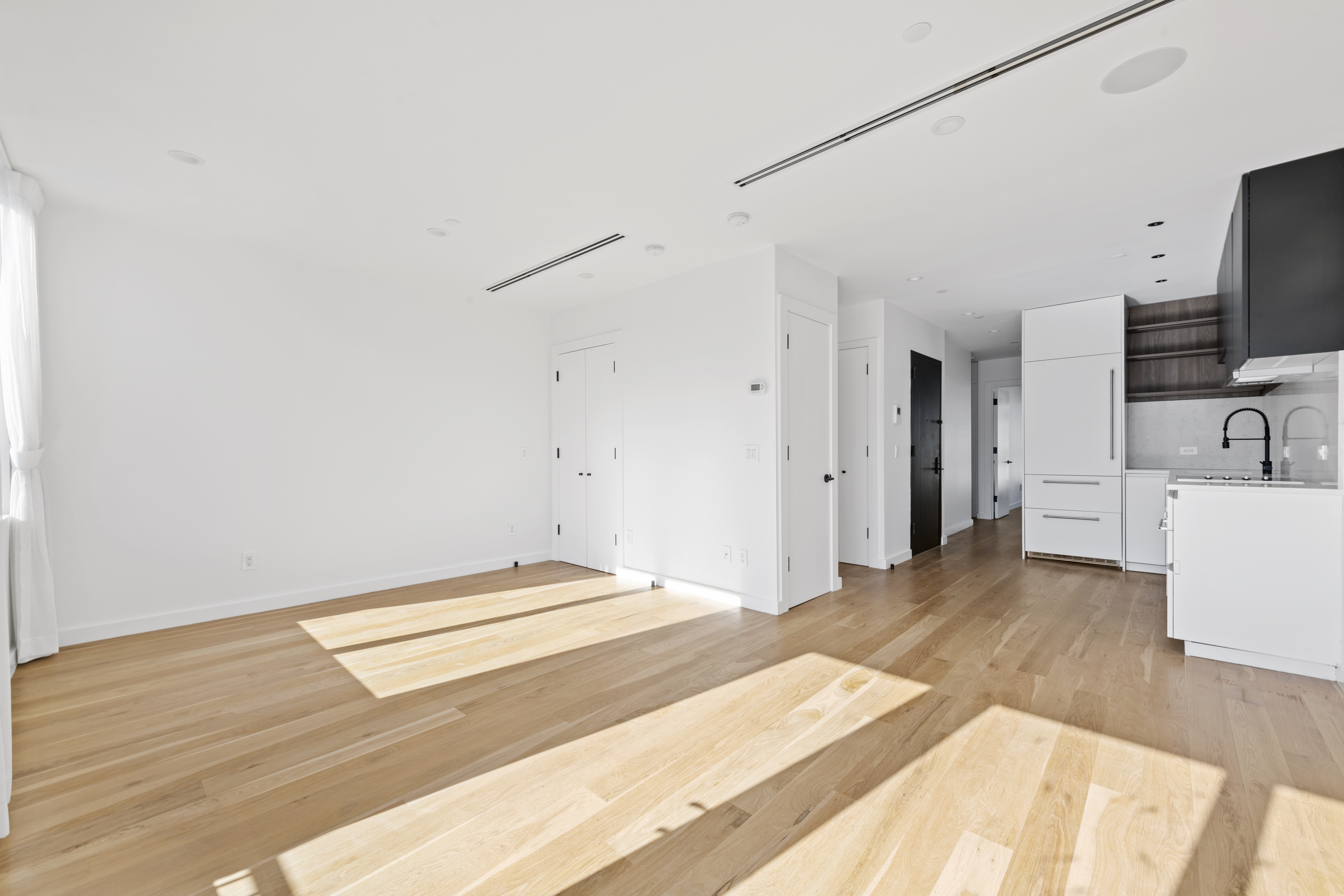 42 Rochester Avenue, Unit 3 Brooklyn, NY 11233 - Photo 1 of 18 a spacious bedroom with a bed and a flat screen tv