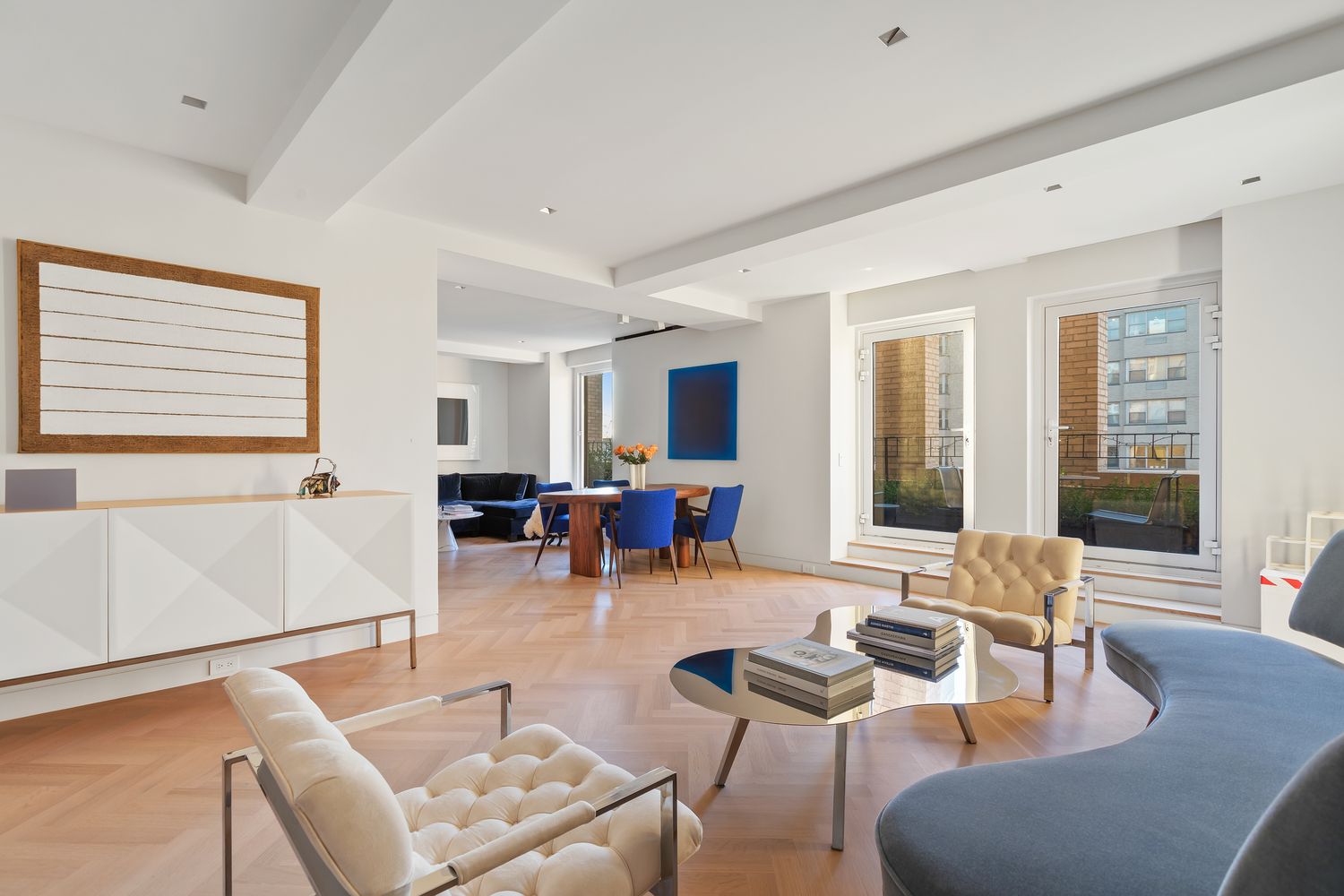 a living room with furniture and floor to ceiling windows