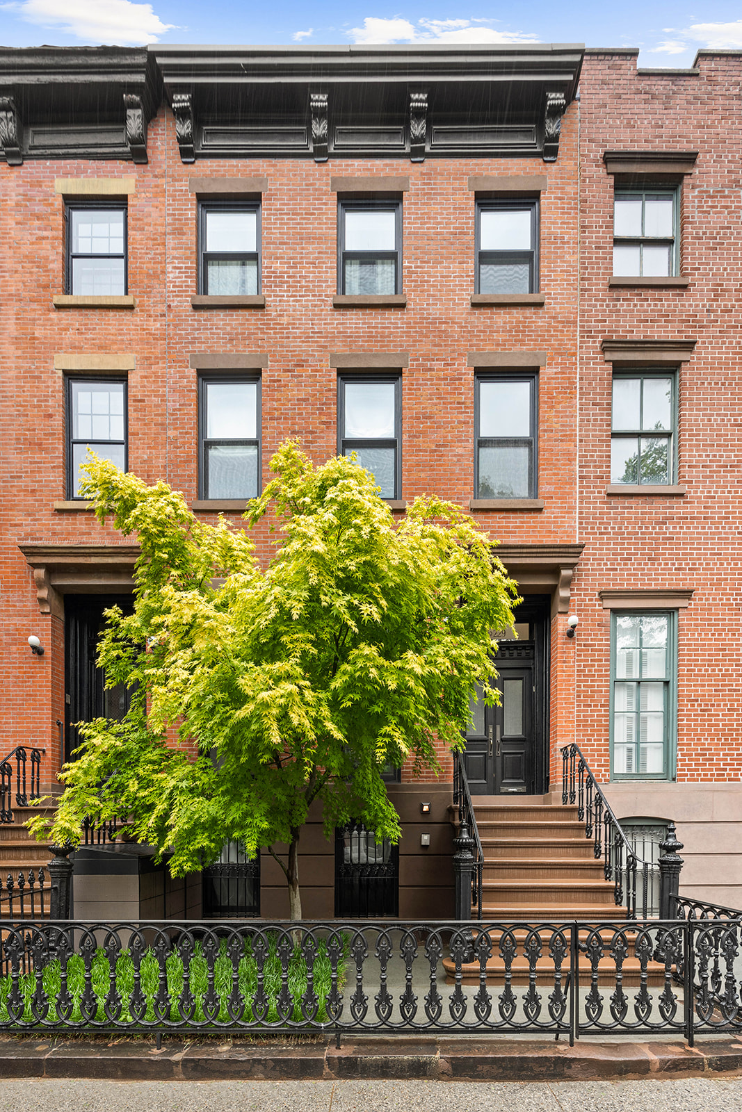 a front view of a house with a garden