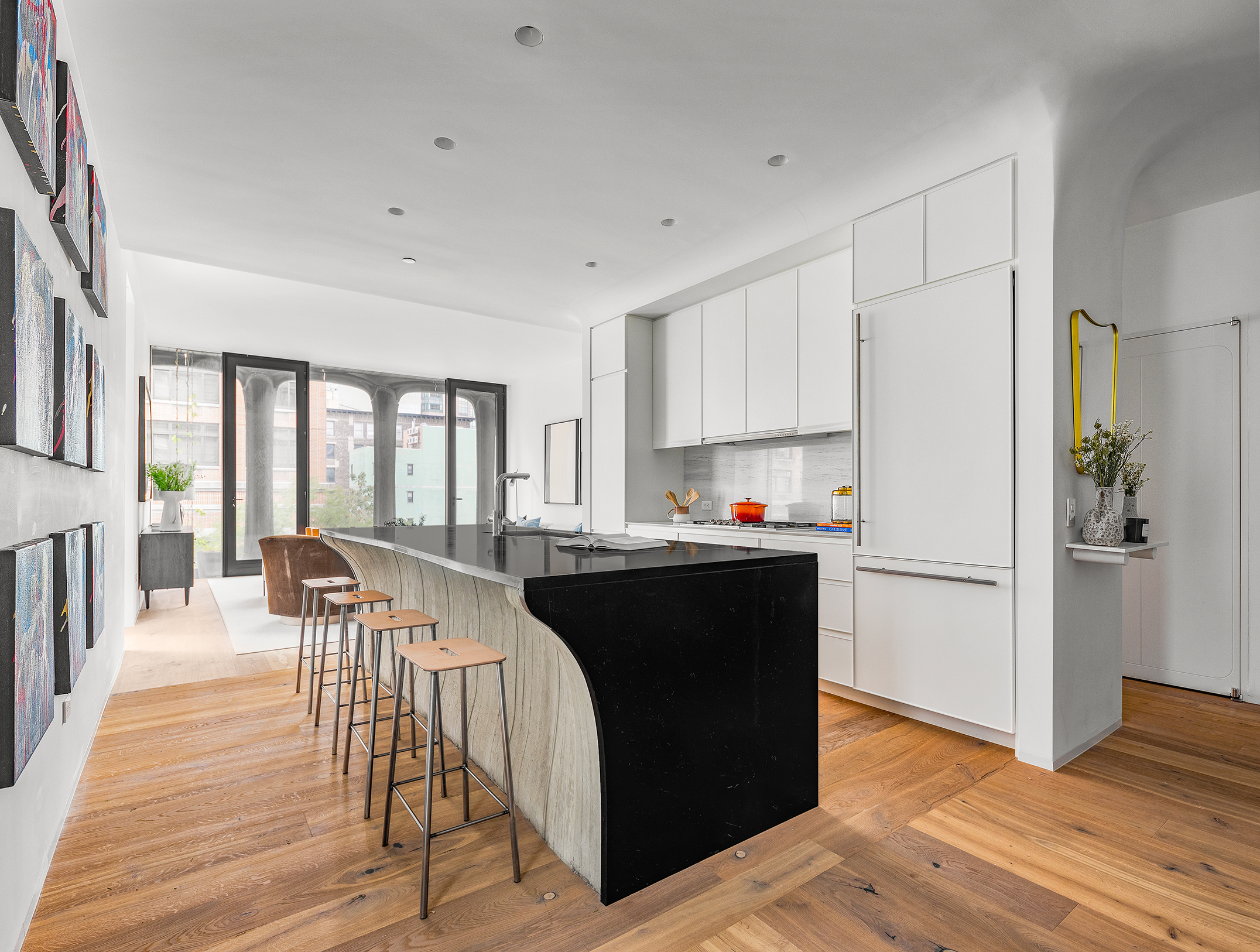 325 West Broadway, Unit 4B Manhattan, NY 10013 - Photo 5 of 17 a kitchen with granite countertop a refrigerator a stove a dining table and chairs with wooden floor