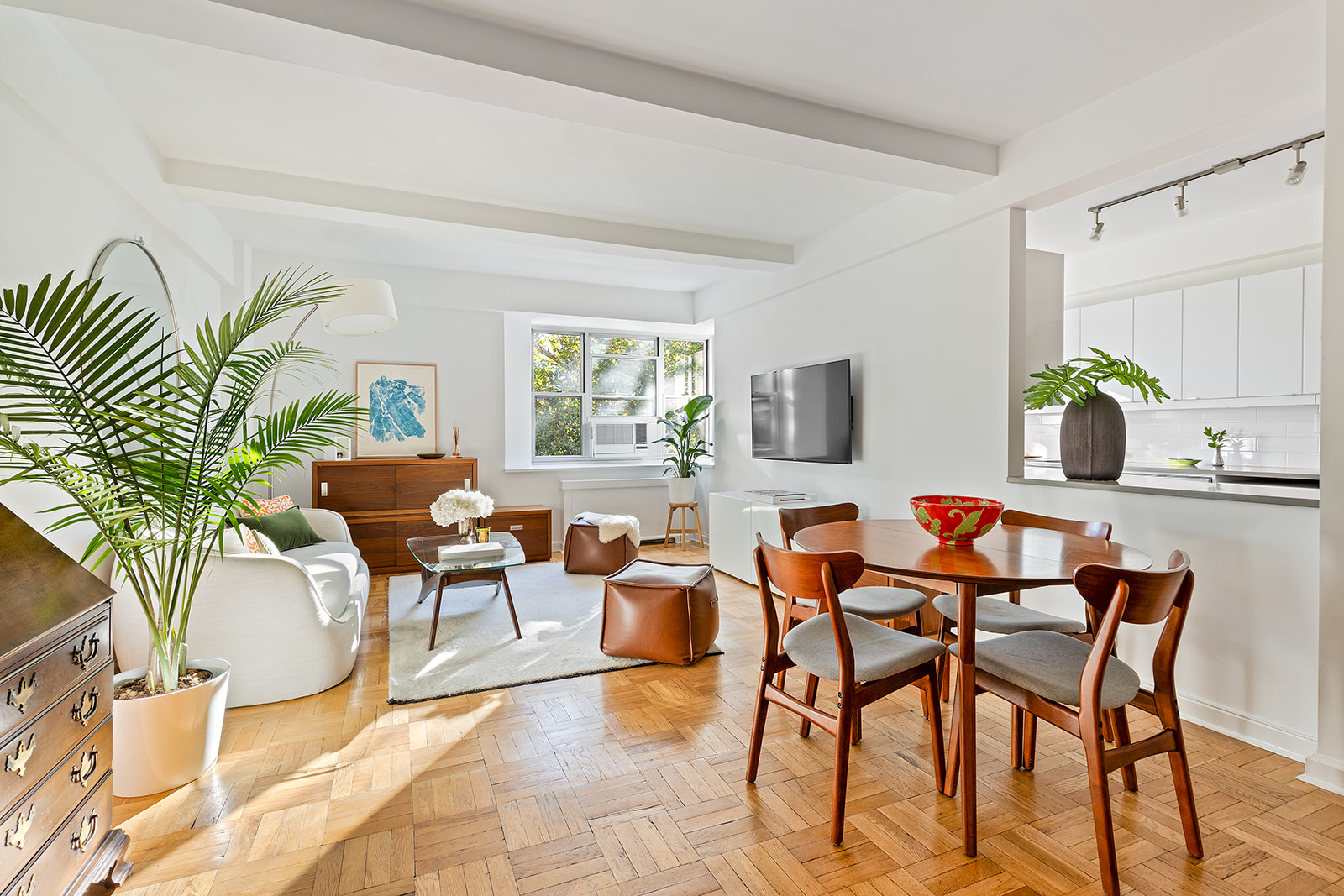 550 Grand Street, Unit G3E Manhattan, NY 10002 - Photo 2 of 7 a living room with patio furniture and a flat screen tv