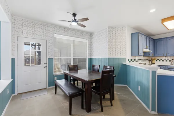 a view of a kitchen with a dining table and chairs