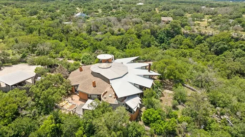 an aerial view of a house with yard and outdoor seating