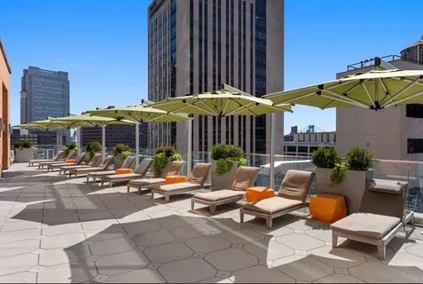 a view of a patio with a table and chairs under an umbrella
