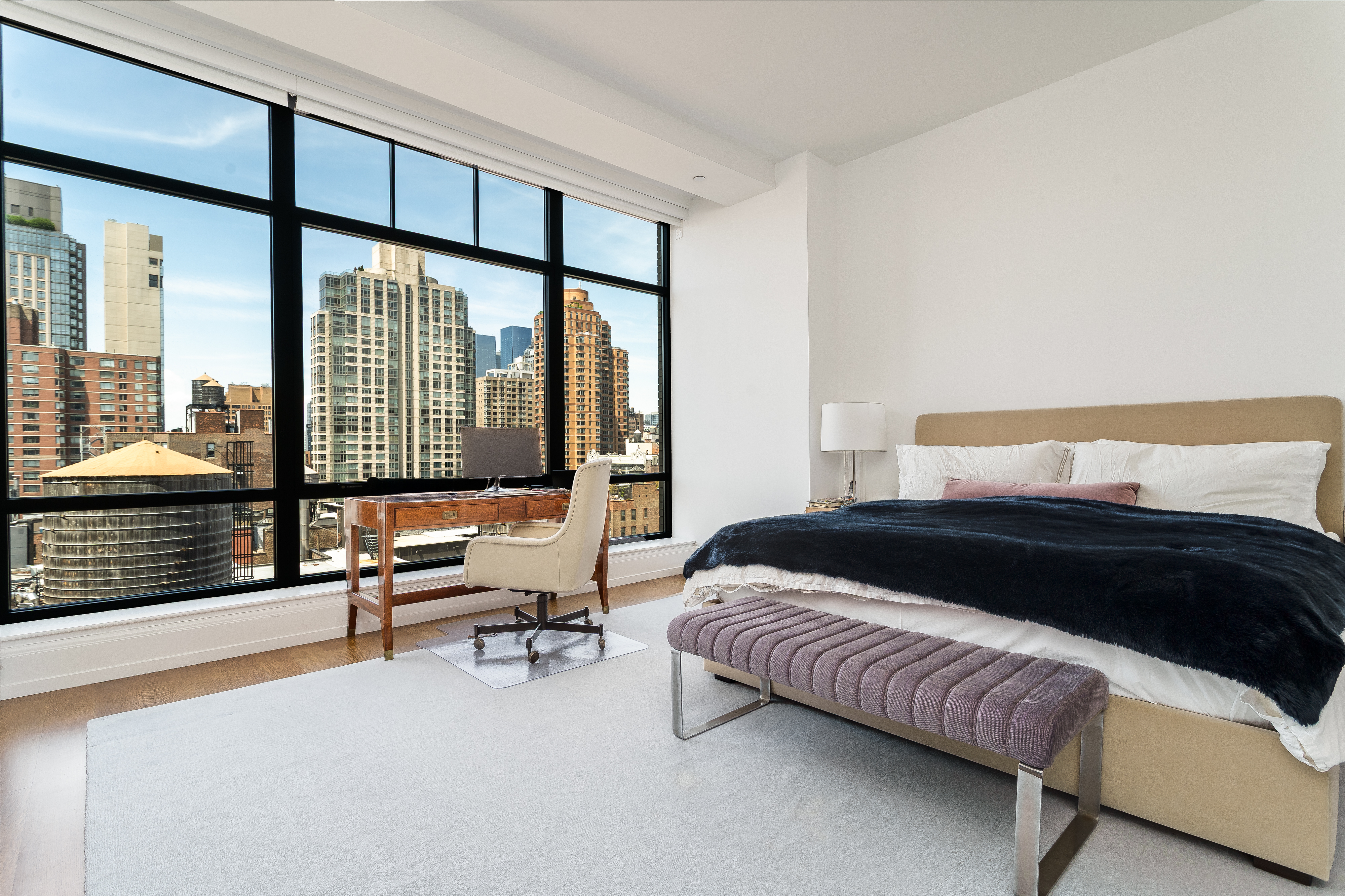 10 Madison Square West, Unit 16F Manhattan, NY 10010 - Photo 10 of 15 a bedroom with a bed and a large window