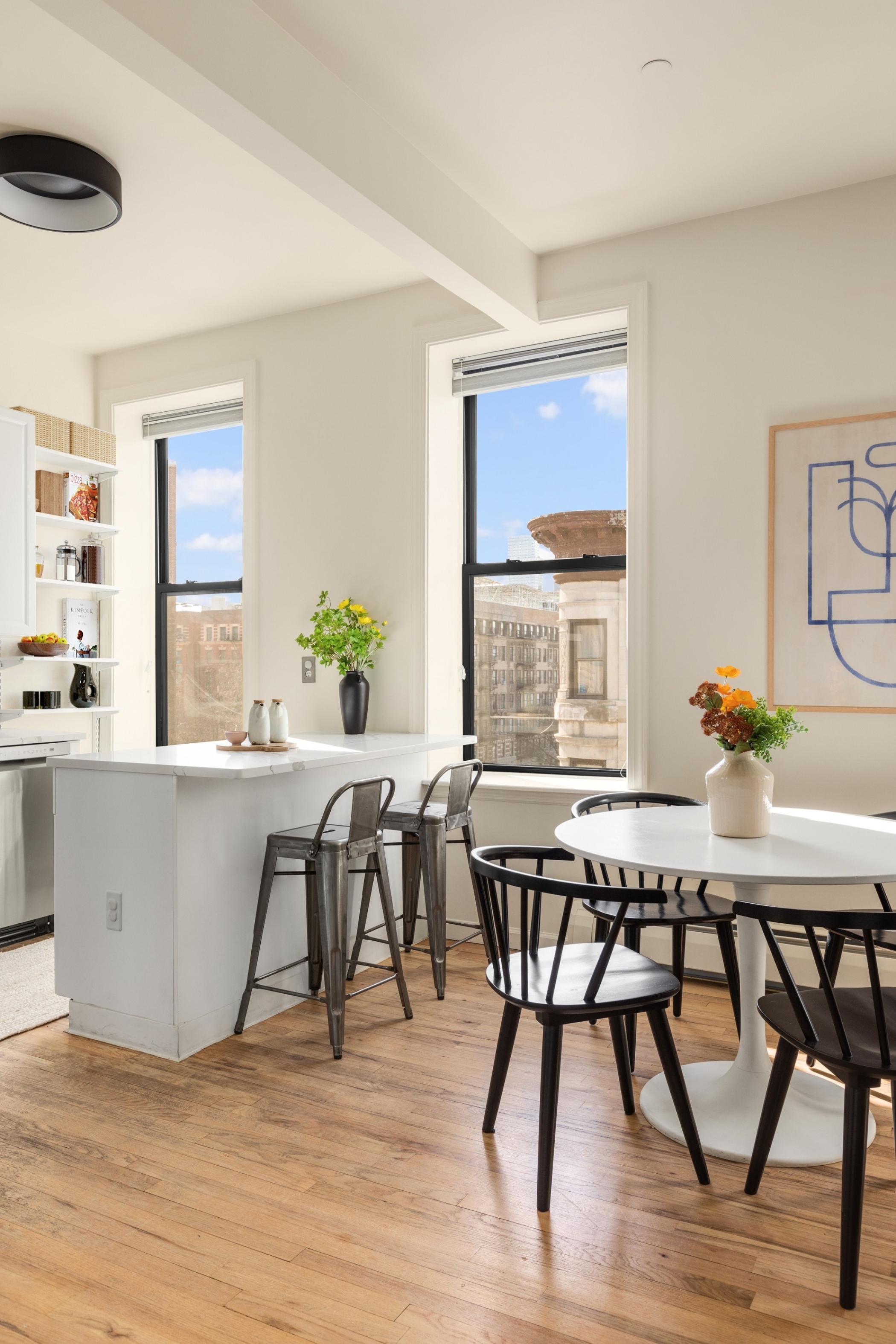61 Lenox Avenue, Unit 5D Manhattan, NY 10026 - Photo 7 of 14 a view of a dining room with furniture and wooden floor