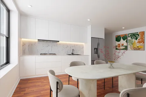 a kitchen with stainless steel appliances a white table chairs and a refrigerator